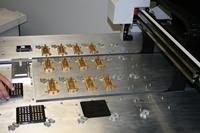 Custom pick-and-place machine used to precisely place micro-lasers for burn in, test and assembly